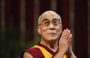The Dalai Lama gestures before speaking to students during a talk at Mumbai University